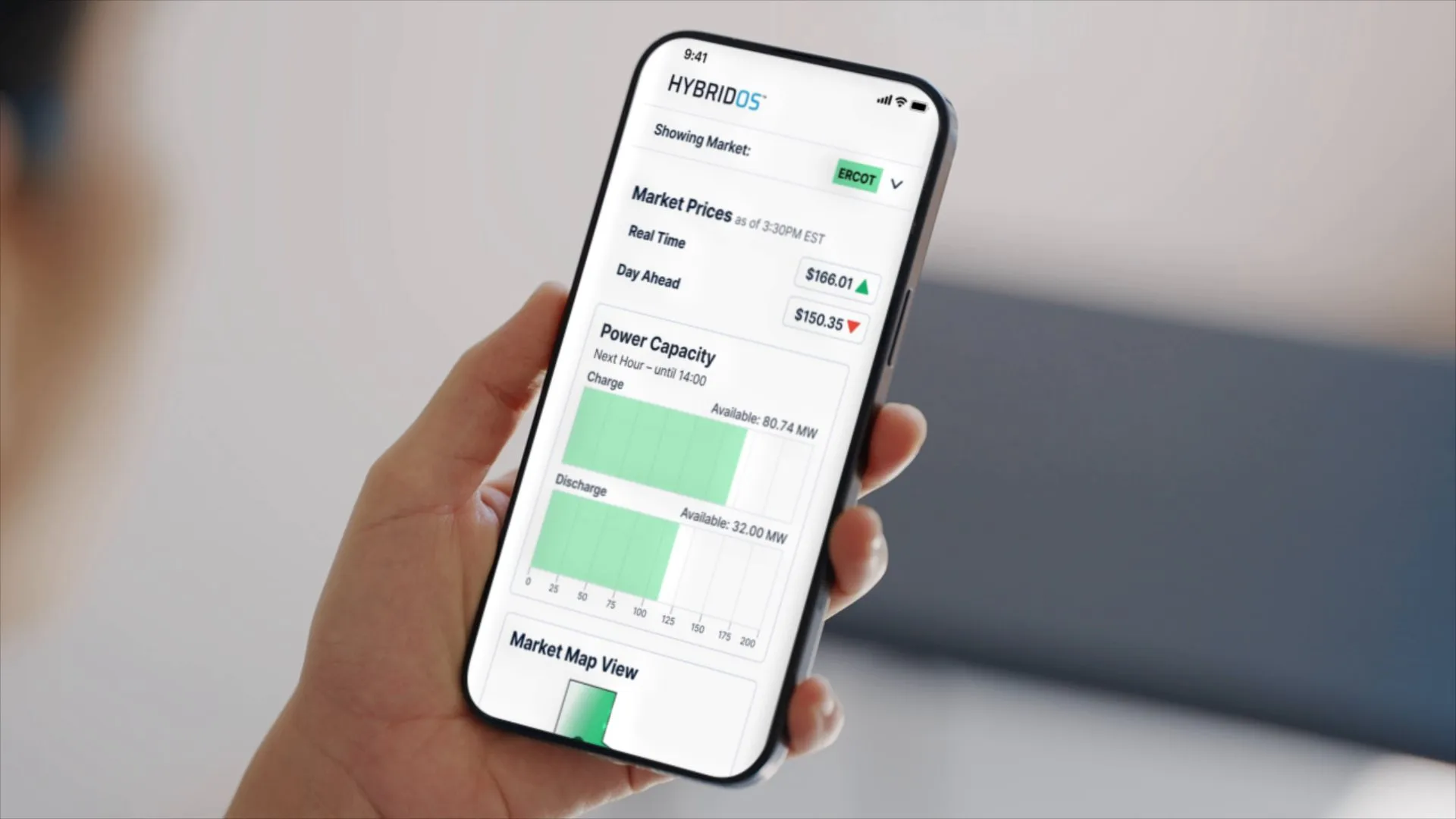 A hand holding a phone that shows HybridOS market prices and power capacity.