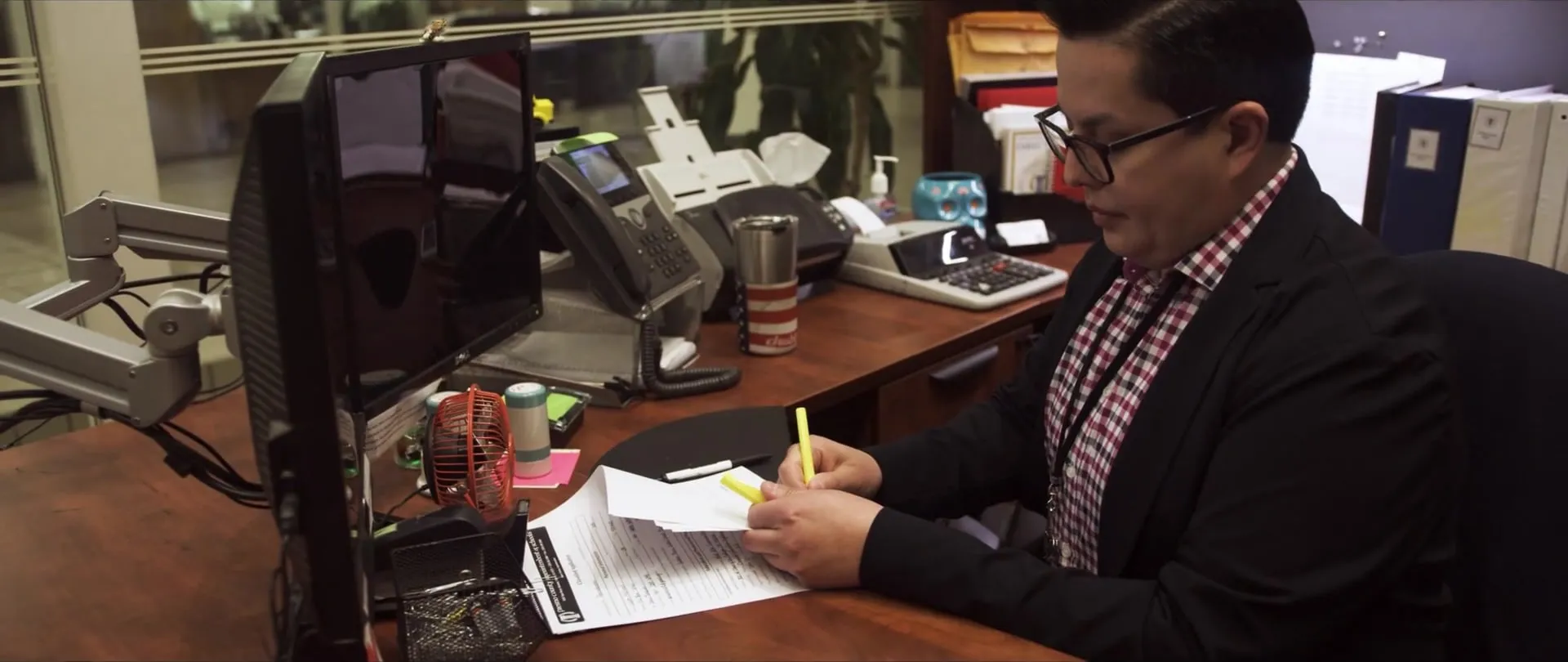 Danny working through paperwork at his desk.